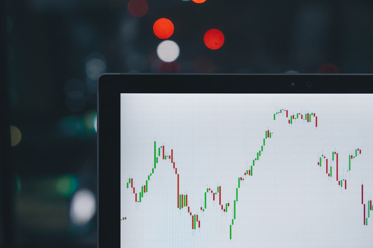 Laptop screen with a rising candlestick chart